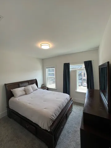 a bedroom with a bed and a night stand