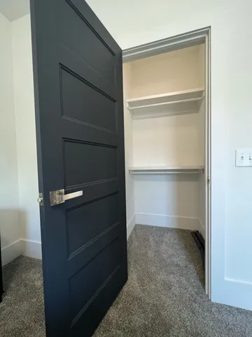 a bedroom with a bed and a desk