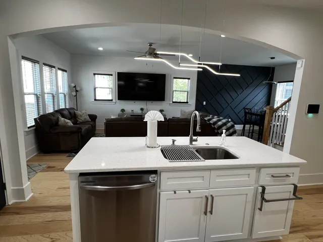 a kitchen with a sink and a stove top oven