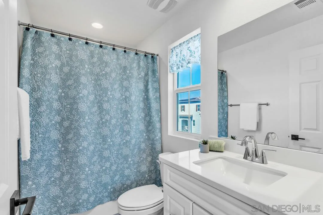 2811 Safflower Street Spring Valley, CA 91977 - Photo 23 of 28 a bathroom with a sink a toilet and a mirror