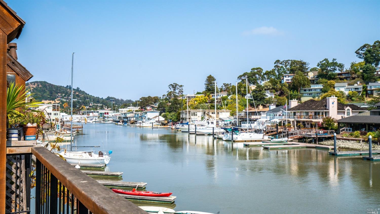 a view of a lake with boats and trees in the background