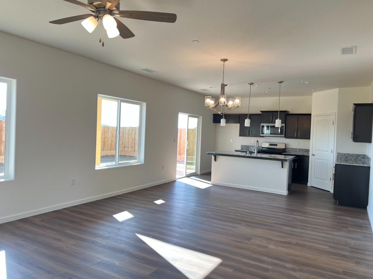 1420 Concord Way Dinuba, CA 93618 - Photo 5 of 16 a large kitchen with granite countertop a large counter top and stainless steel appliances