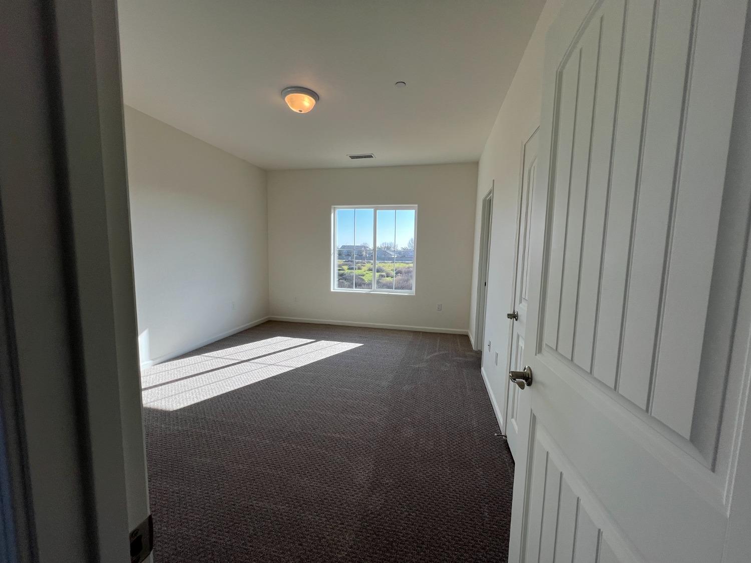 1420 Concord Way Dinuba, CA 93618 - Photo 6 of 16 a view of a hallway with windows
