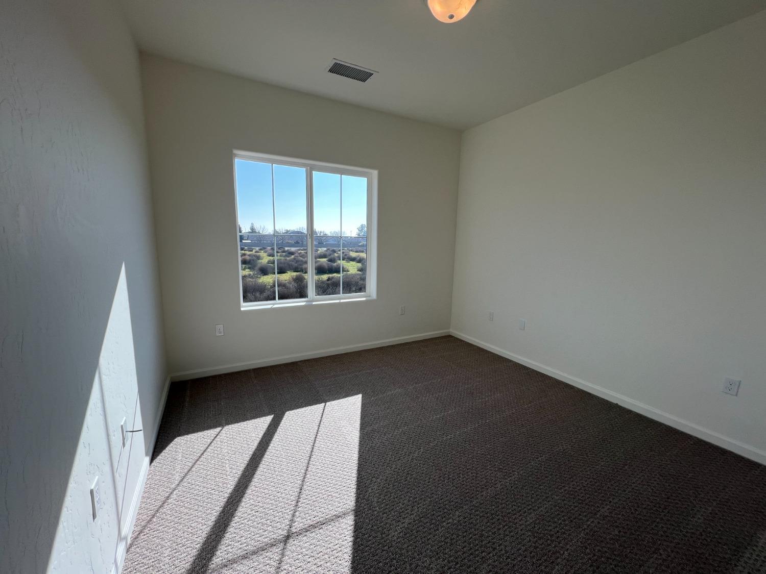 1420 Concord Way Dinuba, CA 93618 - Photo 10 of 16 an empty room with windows