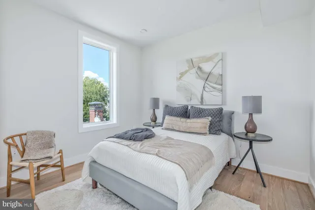 a bedroom with a bed and a chair