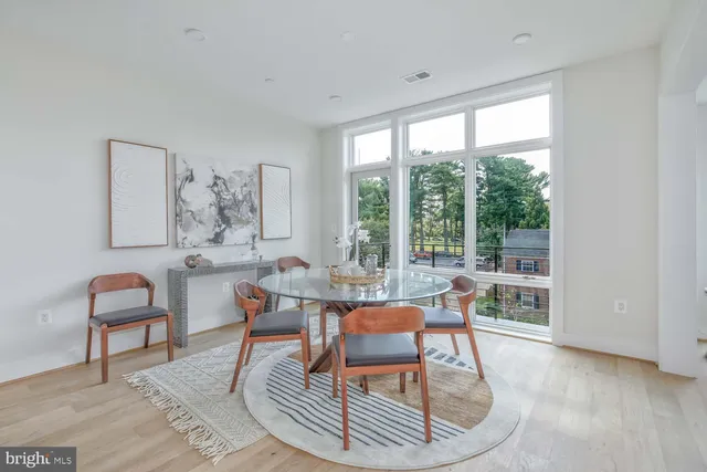 a view of a dining room with furniture a kitchen and chandelier