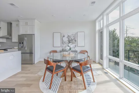 a kitchen with stainless steel appliances granite countertop a refrigerator a oven and a sink