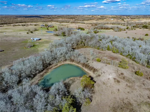 an aerial view of a houses with a yard