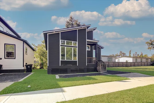 a front view of a house with a garden