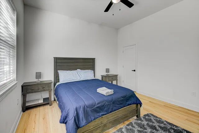 a bedroom with a bed and a window