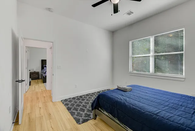a bedroom with a bed and a window