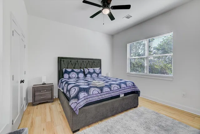 a spacious bedroom with a bed and window