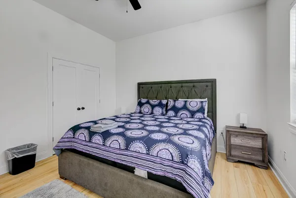 a bedroom with a bed and wooden floor