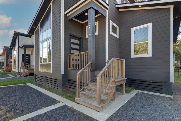 a view of house with a deck and furniture