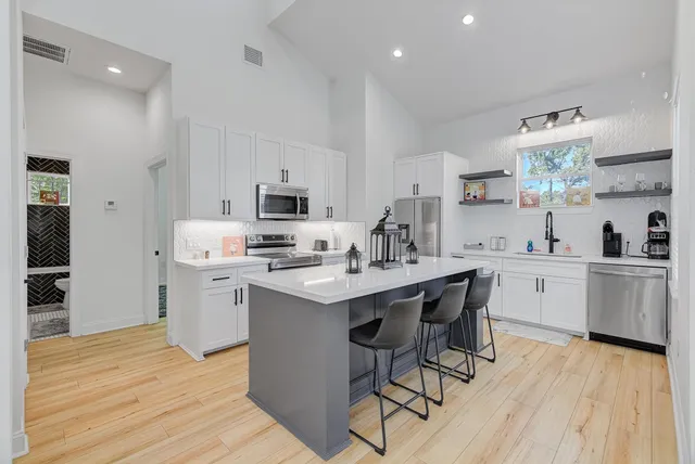 a kitchen with a sink cabinets and wooden floor