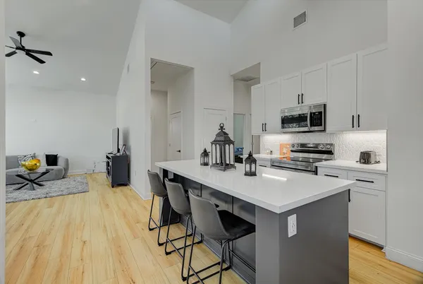 a kitchen with a sink appliances and cabinets