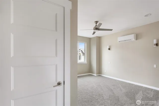 a view of a hallway with a chandelier fan