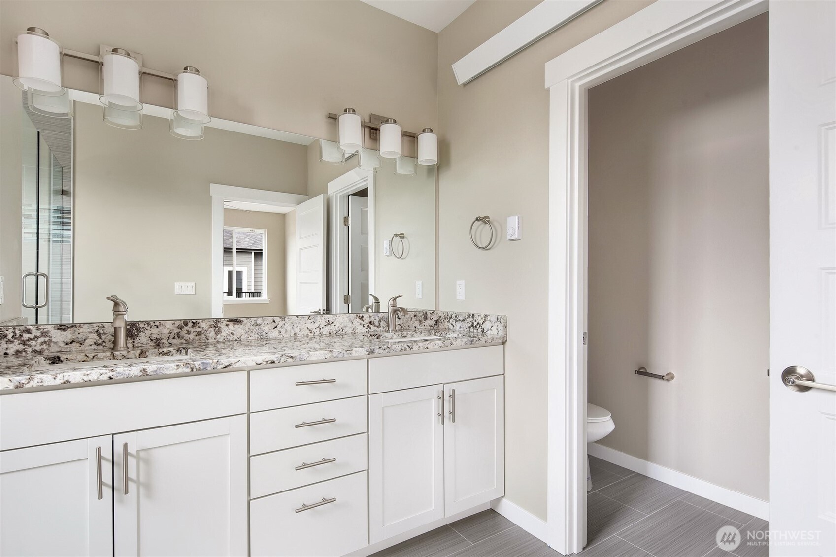 1515 North Waugh Road, Unit B Mount Vernon, WA 98273 - Photo 27 of 28 a bathroom with a granite countertop sink and a mirror