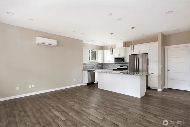 a kitchen with stainless steel appliances a refrigerator sink and white cabinets