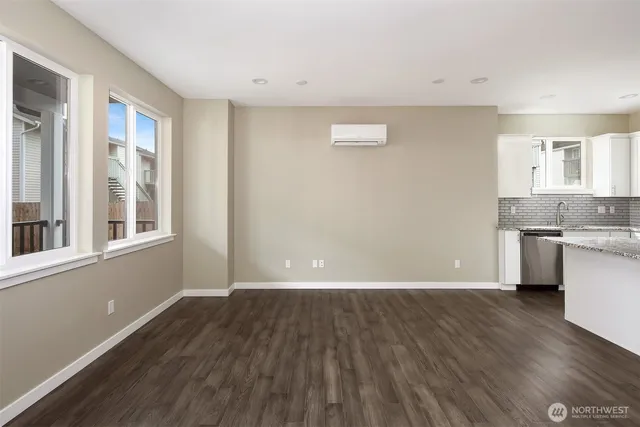 a view of a kitchen with wooden floor and a sink