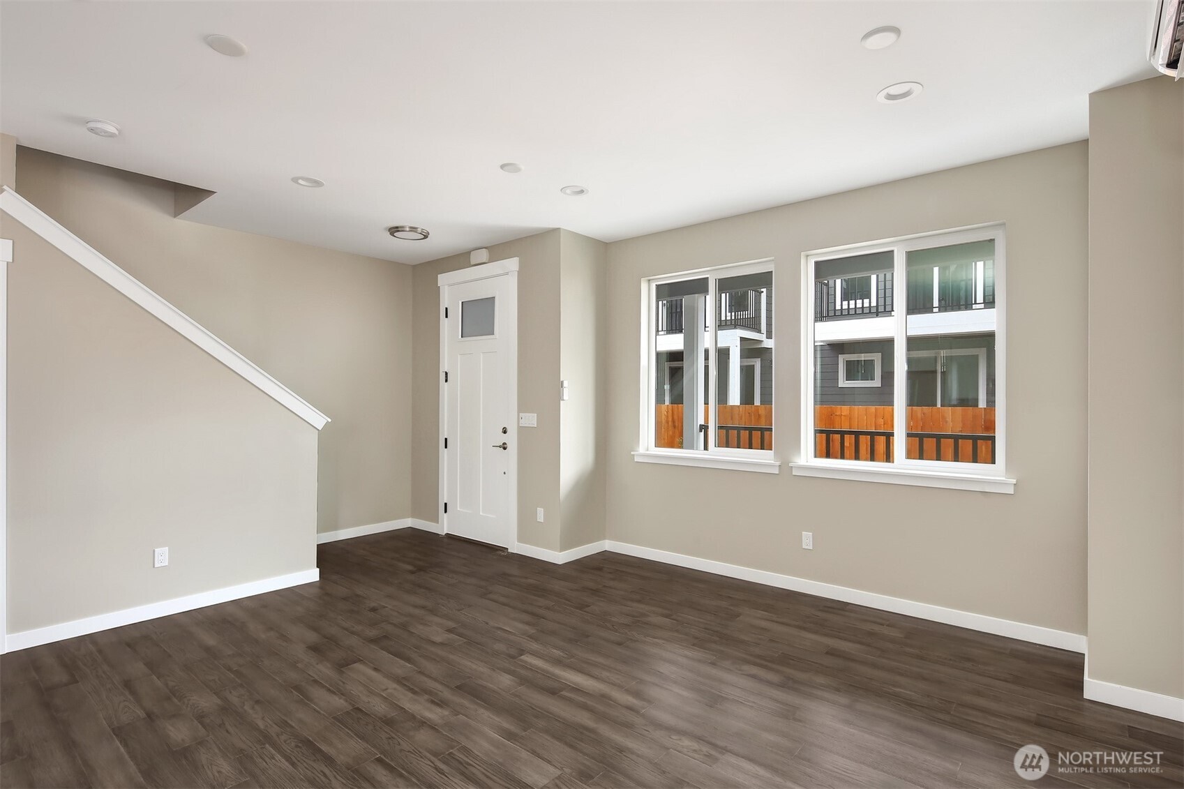 1515 North Waugh Road, Unit B Mount Vernon, WA 98273 - Photo 7 of 28 a view of an empty room with wooden floor and windows
