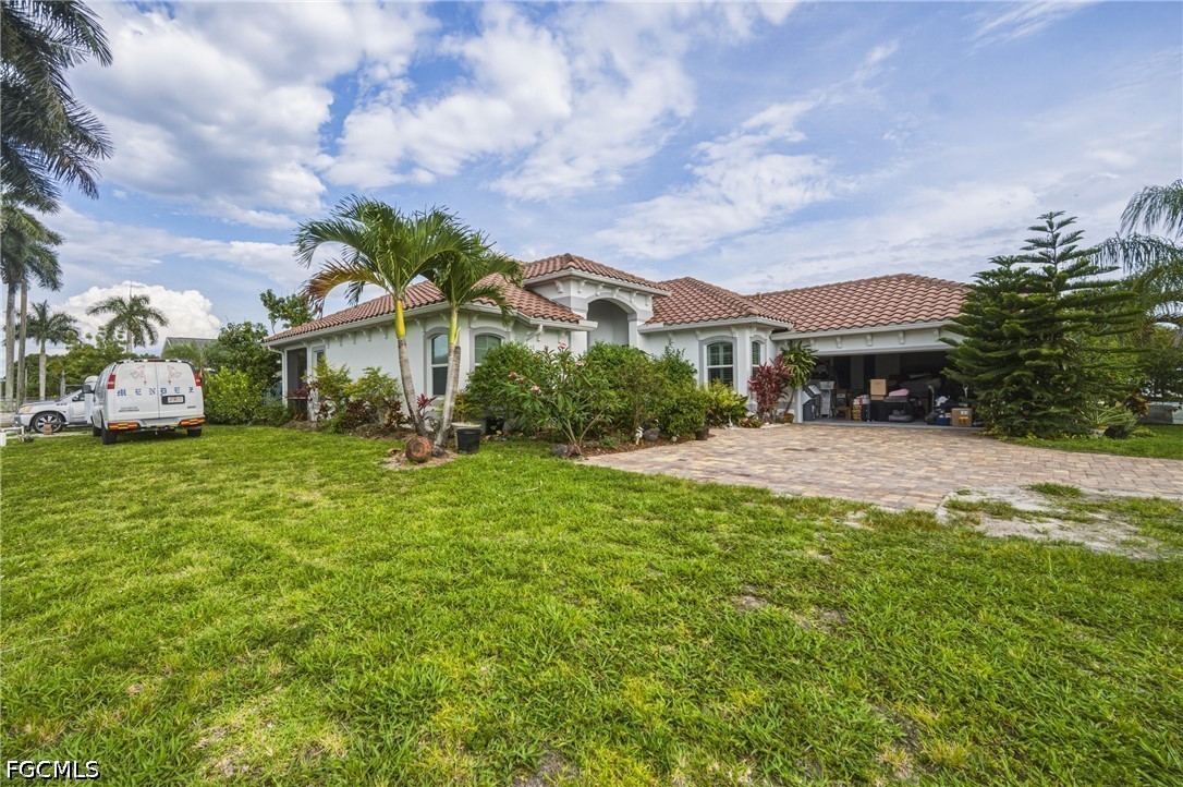 1700 43rd Terrace Southwest Naples, FL 34116 - Photo 3 of 38 a front view of a house with garden