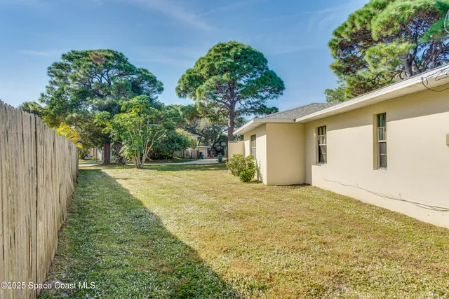a view of a house with yard and sitting area