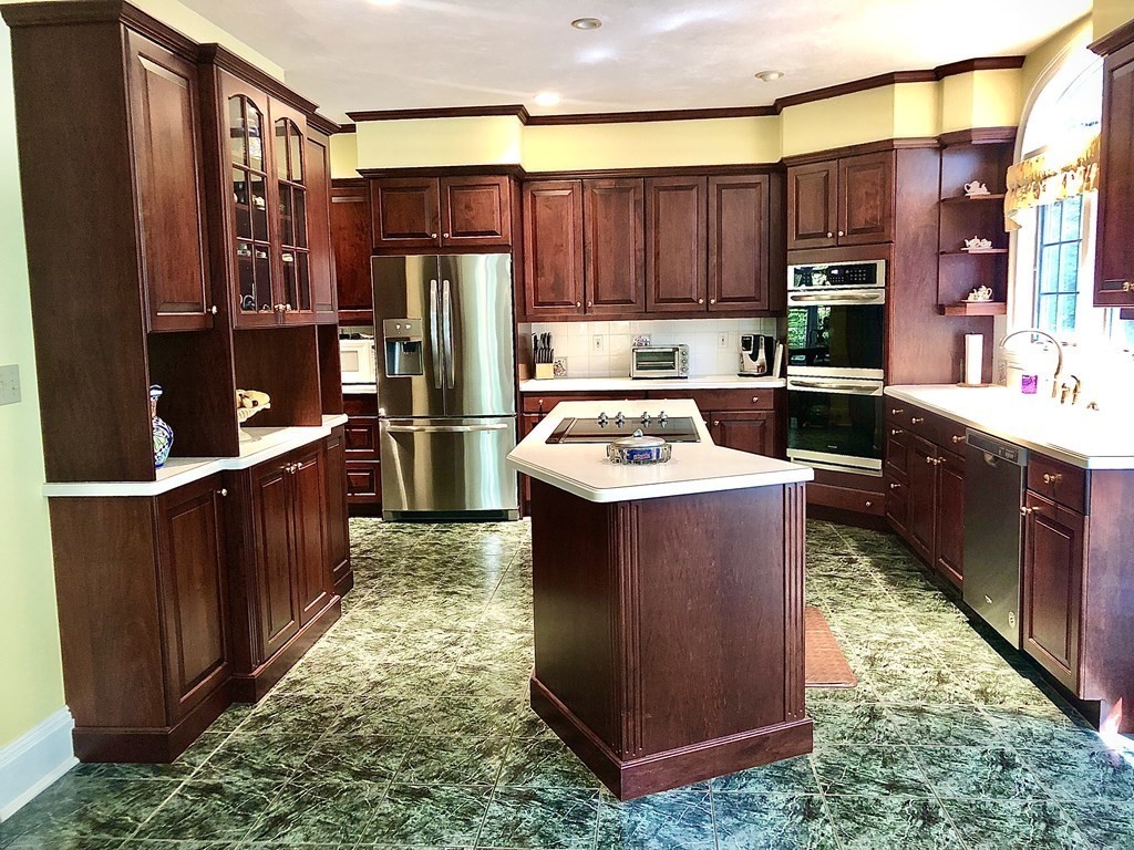 355 Maple Street West Boylston, MA 01583 - Photo 2 of 42 a kitchen with wooden cabinets and a stove top oven