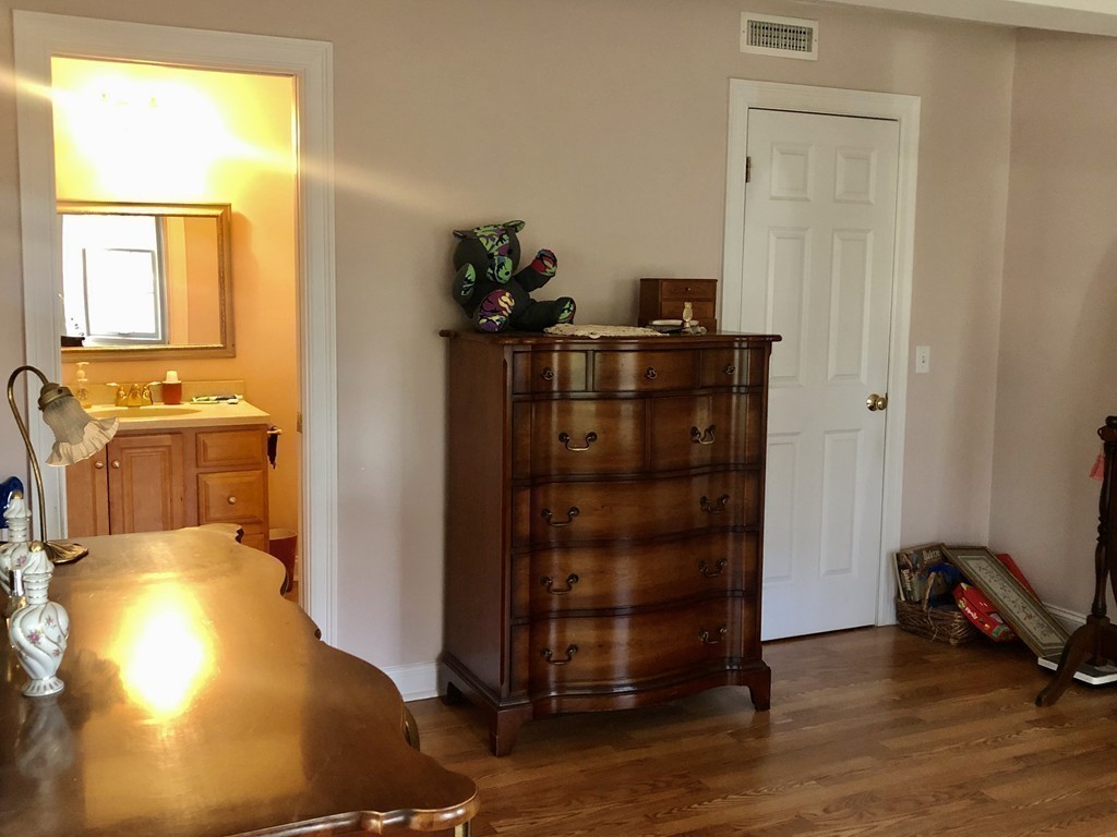 355 Maple Street West Boylston, MA 01583 - Photo 29 of 42 a bedroom with a bed and wooden floor