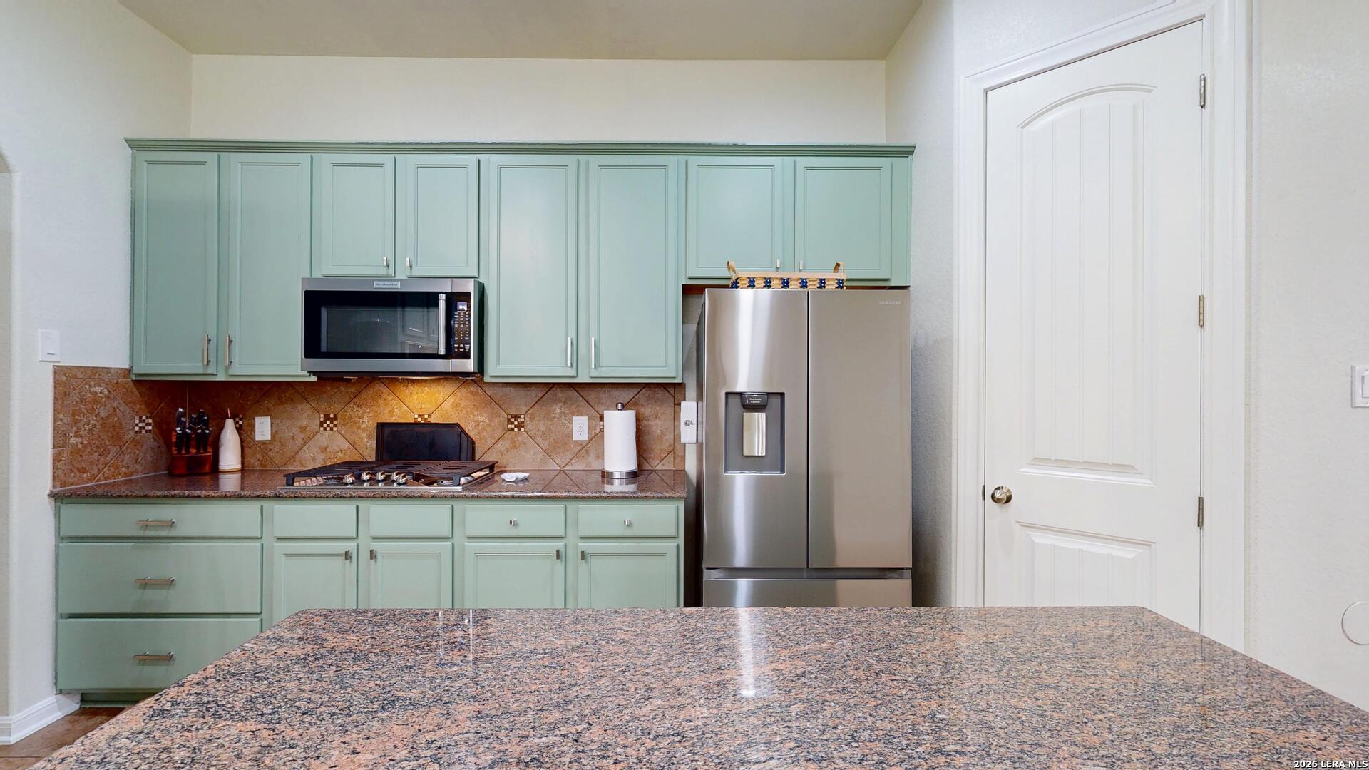 10111 Shallow Bank Converse, TX 78109 - Photo 16 of 65 a kitchen with stainless steel appliances a refrigerator and a microwave