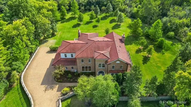 a aerial view of a house with garden space and street view