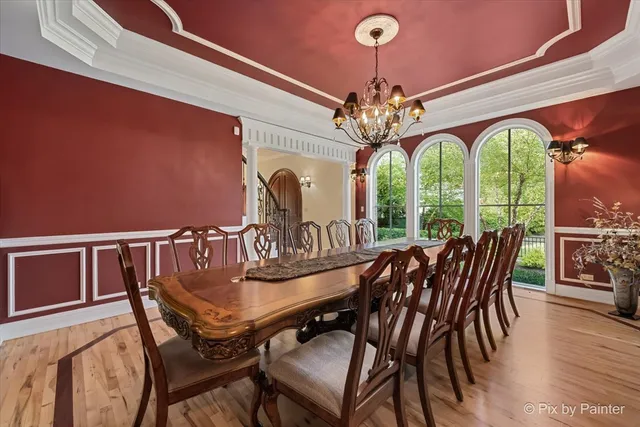 a dining room with stainless steel appliances granite countertop a stove and chairs