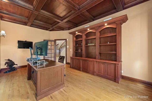 a living room with furniture a flat screen tv and a chandelier