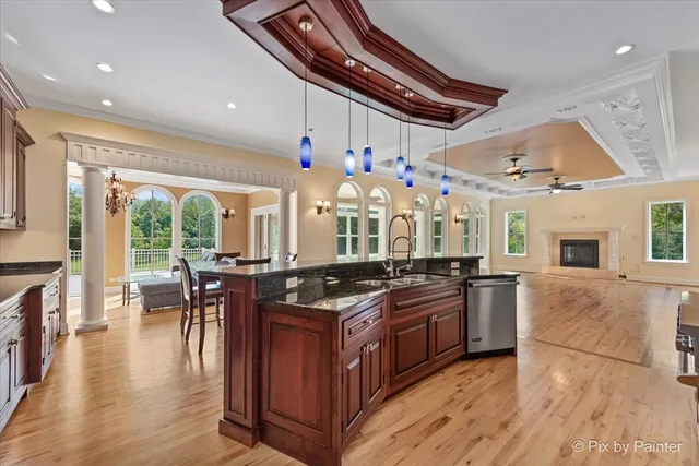 a view of an empty room with a window and a ceiling fan