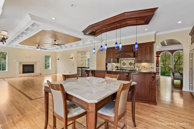 a bed sitting in a spacious bedroom next to a window and a chandelier