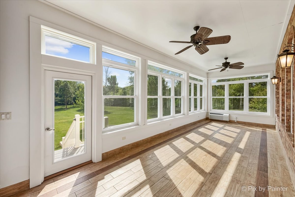27 West Onwentsia Road Lake Forest, IL 60045 - Photo 33 of 84 a view of an empty room with a window and a ceiling fan