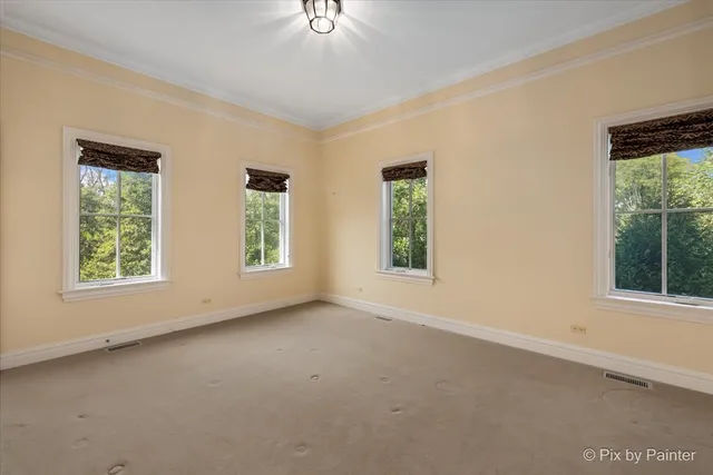 a view of a brick house with a large trees