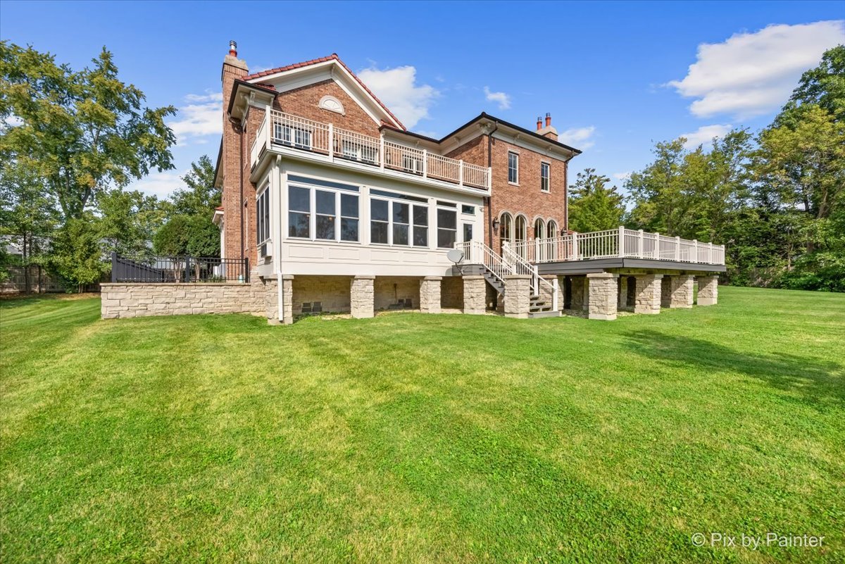 27 West Onwentsia Road Lake Forest, IL 60045 - Photo 80 of 84 a front view of a house with a garden and porch