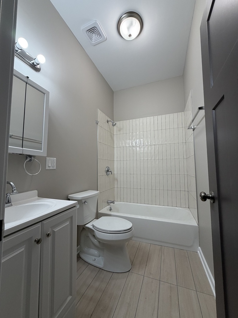 24 North Pulaski Road, Unit 1F Chicago, IL 60624 - Photo 7 of 10 a bathroom with a sink a toilet and shower