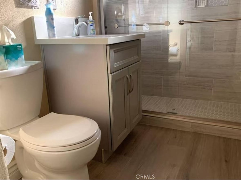 12964 Roswell Avenue Chino, CA 91710 - Photo 13 of 14 a white toilet sitting next to a bathroom sink