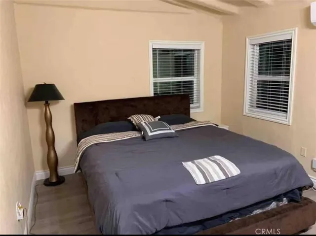 a bed sitting in a bedroom next to a window