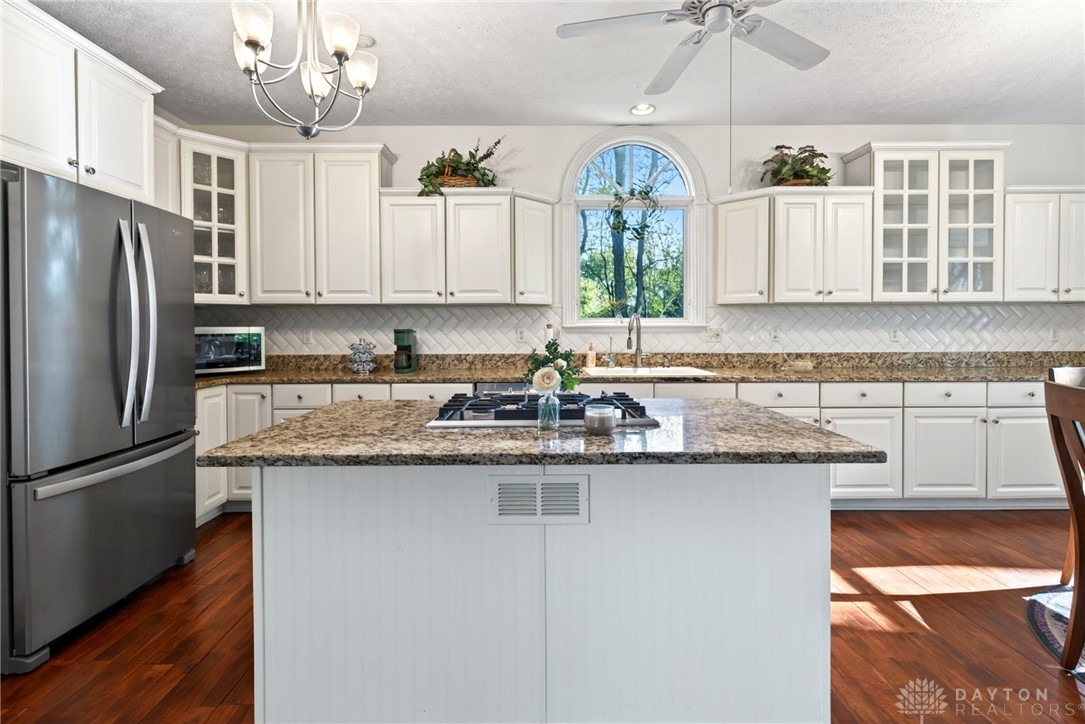330 South Alpha Bellbrook Road Bellbrook, OH 45305 - Photo 17 of 87 This spacious kitchen offers a central island, rich hardwood flooring, and ample cabinetry for culinary pursuits.