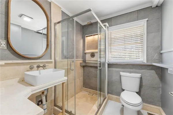 a bathroom with a sink a toilet and a mirror