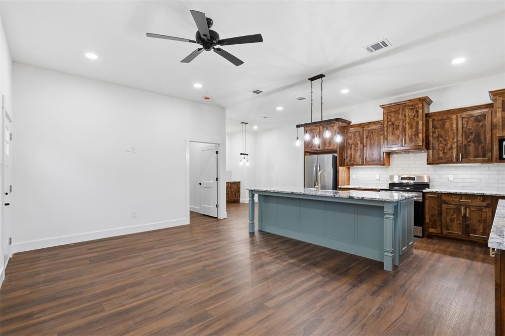 1413 Ridgeview Circle Granbury, TX 76048 - Photo 8 of 35 Open-concept living space featuring wood-finish flooring, recessed lighting, and a contemporary ceiling fan