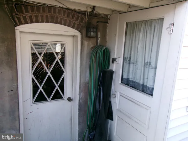 a view of empty room with a fireplace and windows