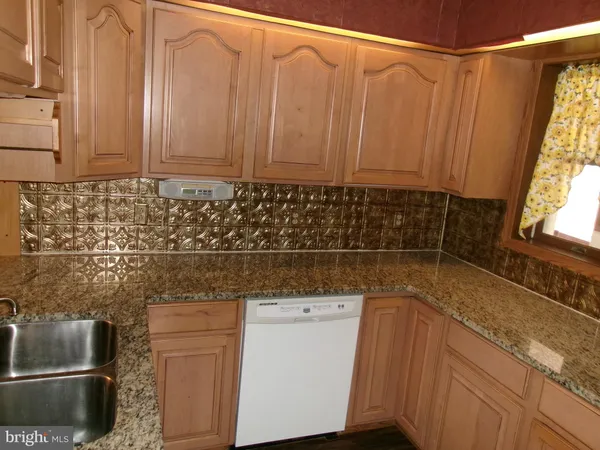 a bathroom with a sink and a shower curtain