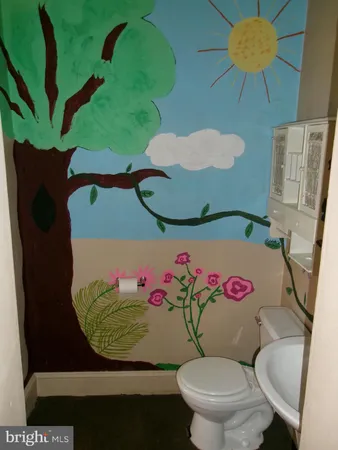 a bathroom with a sink mirror and toilet