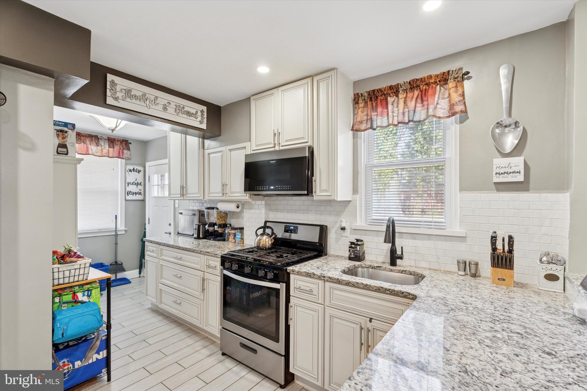 527 Arbor Road Cheltenham, PA 19012 - Photo 8 of 25 a kitchen with stainless steel appliances a stove a sink and a refrigerator