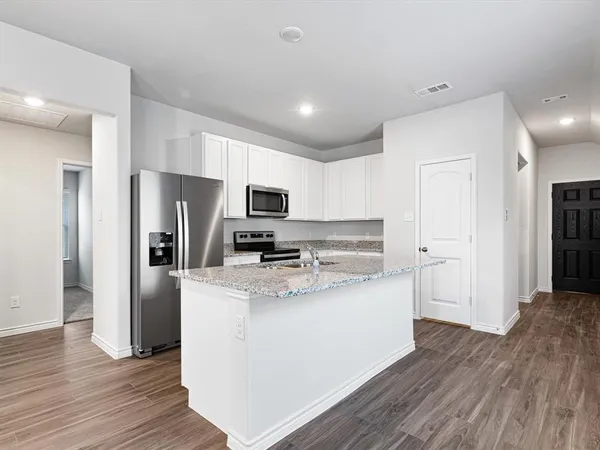 a kitchen with stainless steel appliances a refrigerator sink and microwave
