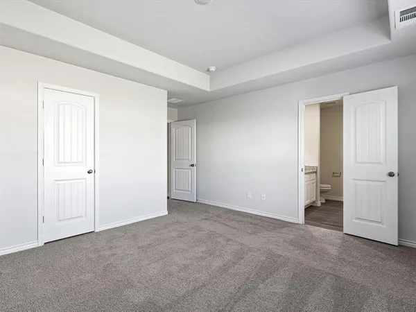 a view of an empty room and closet area